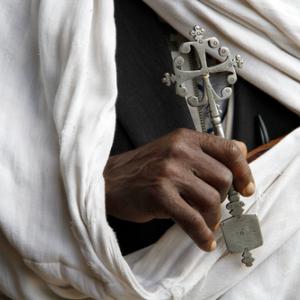 Hand holding Coptic cross.