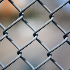 Chain link fence. Image courtesy Bobkeenan Photography / shutterstock.com.