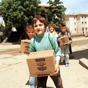 Refugees carry USAID packages, Northfoto / Shutterstock.com