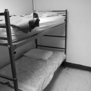 Beds in a homeless shelter, Nathan Kresge / Shutterstock.com