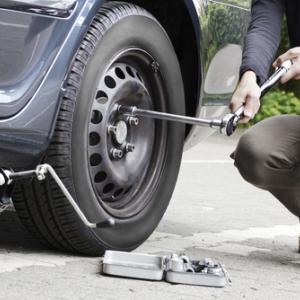 Changing a tire, mezzotint / Shutterstock.com