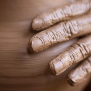  Potter's hands on a wheel, bluelake / Shutterstock.com