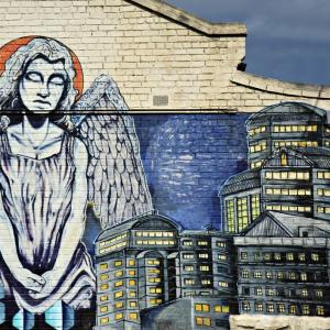 An angel surveys a city. Image courtesy Neale Cousland/shutterstock.com