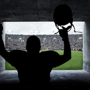 Football player in a tunnel, Brocreative / Shutterstock.com