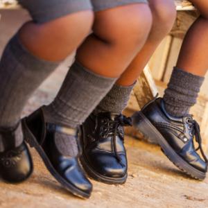 Two schoolchildren wait for the bus, Nolte Lourens / Shutterstock.com