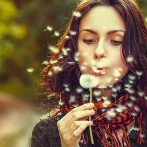 Girl blowing on dandelions, Volodymyr Goinyk / Shutterstock.com