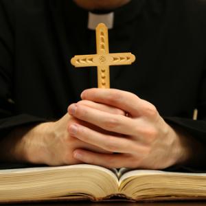 Priest reading from the Bible,  Africa Studio / Shutterstock.com