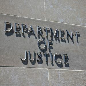 Sign on the exterior of the Department of Justice. Photo courtesy kenkistler/shu