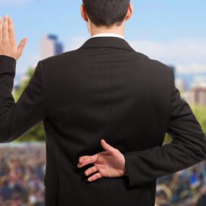 Politician swearing oath with fingers crossed, Minerva Studio / Shutterstock.com