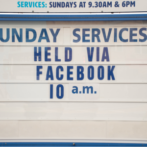 A church sign stating that online Sunday services are being held via Facebook.