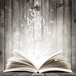 An open book with letters in flight. Image courtesy robert_s/shutterstock.com.