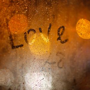 'Love' written on window in the rain, Wolf__ / Shutterstock.com