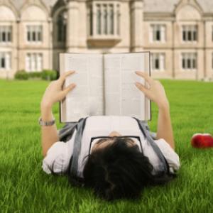 A female college student reads a book. Image courtesy Creativa/shutterstock.com