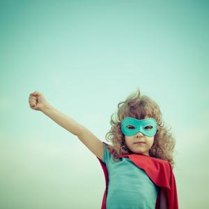 Girl dressed up like a superhero, Sunny studio / Shutterstock.com