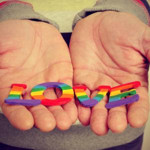 Hands holding the word "Love." Image courtesy nito/shutterstock.com