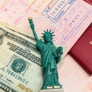 Passport visa and money. Image courtesy mariakraynova/shutterstock.com.