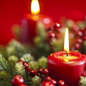 An advent candle burns in the wreath. Image courtesy 3523studio/shutterstock.com