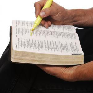 Man highlighting Scripture, James Steidl / Shutterstock.com