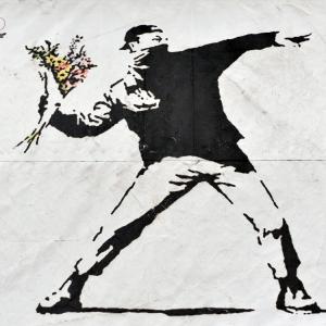 Banksy graffiti piece: 1000 Words / Shutterstock.com