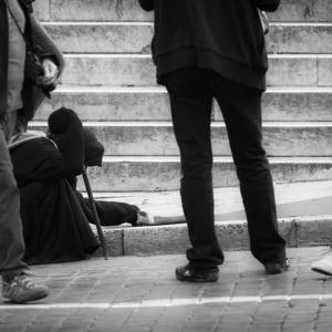 Beggar among a crowd, Lasse Ansaharju / Shutterstock.com