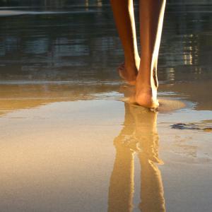 Walking on a beach. Image via mimagephotography/shutterstock.com