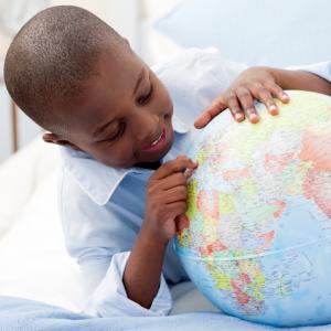 Small boy looking at his globe, wavebreakmedia / Shutterstock.com