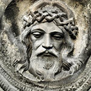 Face of Jesus from an old cemetery statue. Photo by Brasiliao/Shutterstock.com.
