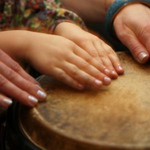 Hands of music teacher and student, Anna Jurkovska / Shutterstock.com