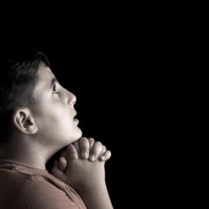 Portrait of a boy praying, Emin Ozkan / Shutterstock.com