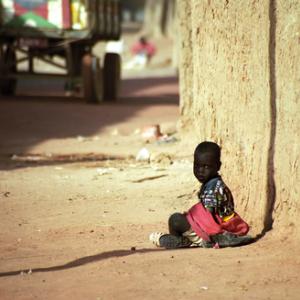 Photo: Child sitting in the dust in  Attila JANDI / Shutterstock.com