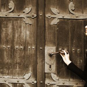 Photo: Young woman near church doors, Lisa A / Shutterstock.com