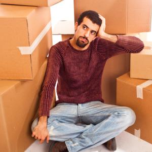 Man among moving boxes, William Perugini / Shutterstock.com