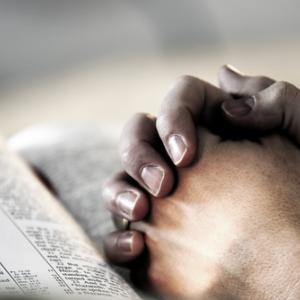 Photo: Hands clasped in prayer. Lincoln Rogers / Shutterstock.com