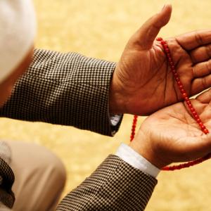 Hands with Muslim prayer beads, Omer N Raja / Shutterstock.com