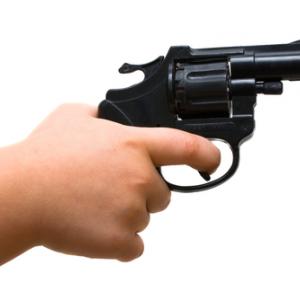 A child points a gun. Image courtesy Marek H./shutterstock.com