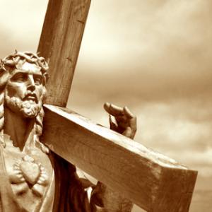Jesus holding the cross, Kobets / Shutterstock.com