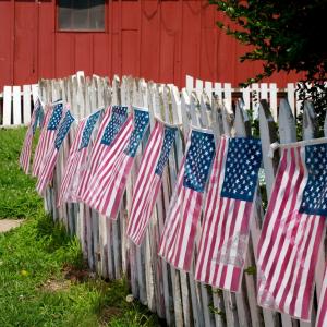 Flag decorated white picket fence, Bill Fehr / Shutterstock.com