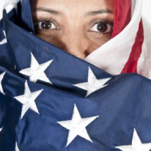 Woman wrapped in an American flag. Image courtesy Rob Byron/shutterstock.com.