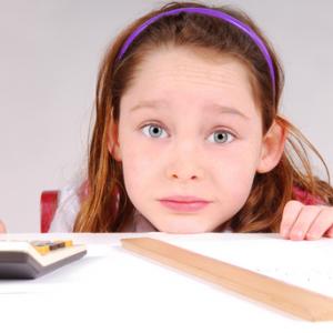 Girl working on math homework. Image by Cheryl Casey/Shutterstock.com.