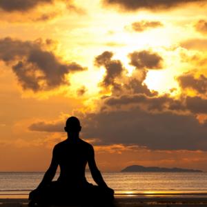 Man silhouette doing yoga, aragami12345s / Shutterstock.com