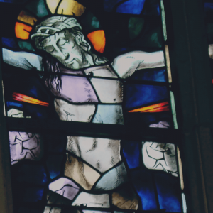 a stained glass window depict Jesus on the cross.