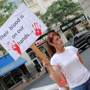 Victoria Ann Thorpe protests against the death penalty outside of a Spokane mall