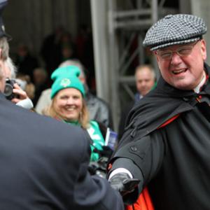 Cardinal Timothy M. Dolan greets a firefighter at the annual St. Patrick’s Day p