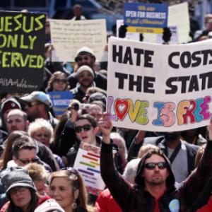 Demonstrators gather to protest the religious freedom bill signed by Gov. Mike P