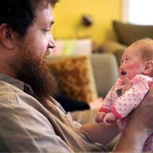 Eric Brown holds his two-month-old daughter, Pearl Joy, on Oct. 1, 2012. 