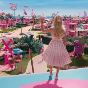 Barbie wears a pink dress and looks out over Barbieland