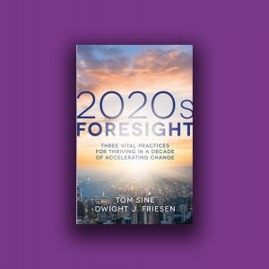 The cover of the book "2020s Foresight" shows the sky at sunrise and a city beneath it.