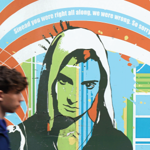 The image shows a mural of Sinead O'Connor, with the words "Sinead you were right all along. We were wrong. So sorry." 