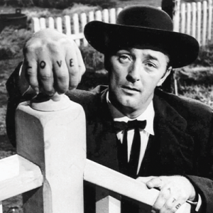 Harry Powell, played by actor Robert Mitchum, with his hands on a fence, showing LOVE tattooed on his knuckles.