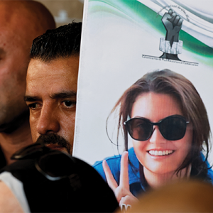 A mourner in the Israeli-occupied West Bank holds an image of Ayşenur Ezgi Eygi, a 26-year-old American volunteer with December 2024 International Solidarity Movement who was killed by Israeli forces in Nablus on Sept. 6, 2024.